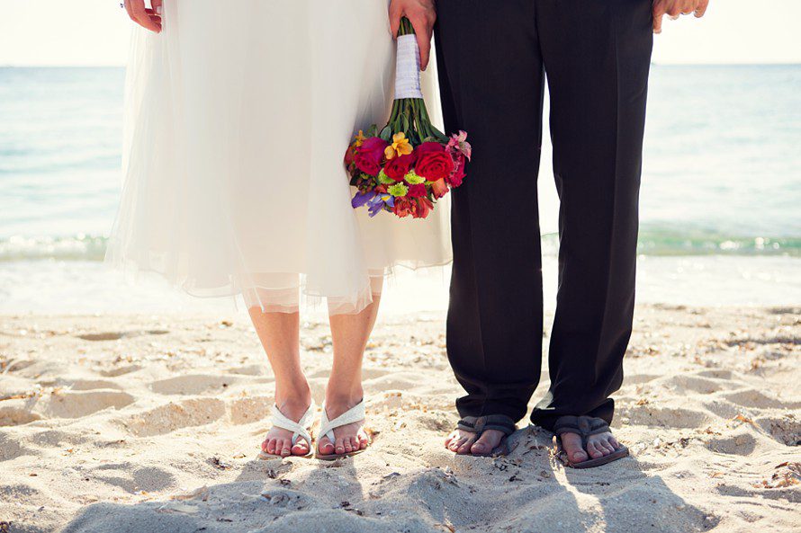 bride and groom in sand for beach wedding