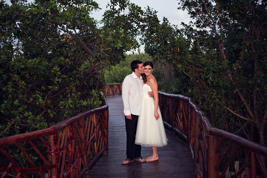 Bride and groom on bridge at Occidental Grand Cozumel