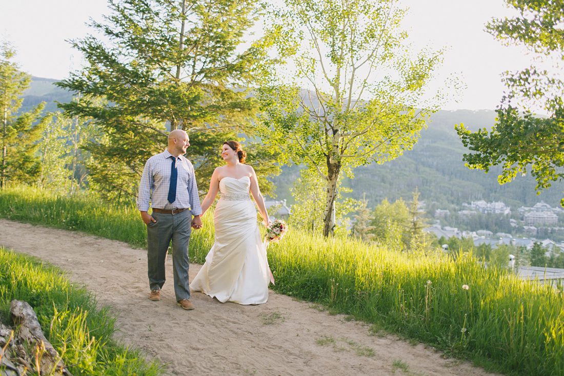 Bride and groom walking at sunset in Beaver Creek