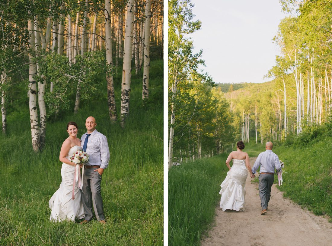 Bride and groom walking along aspen trees in Vail