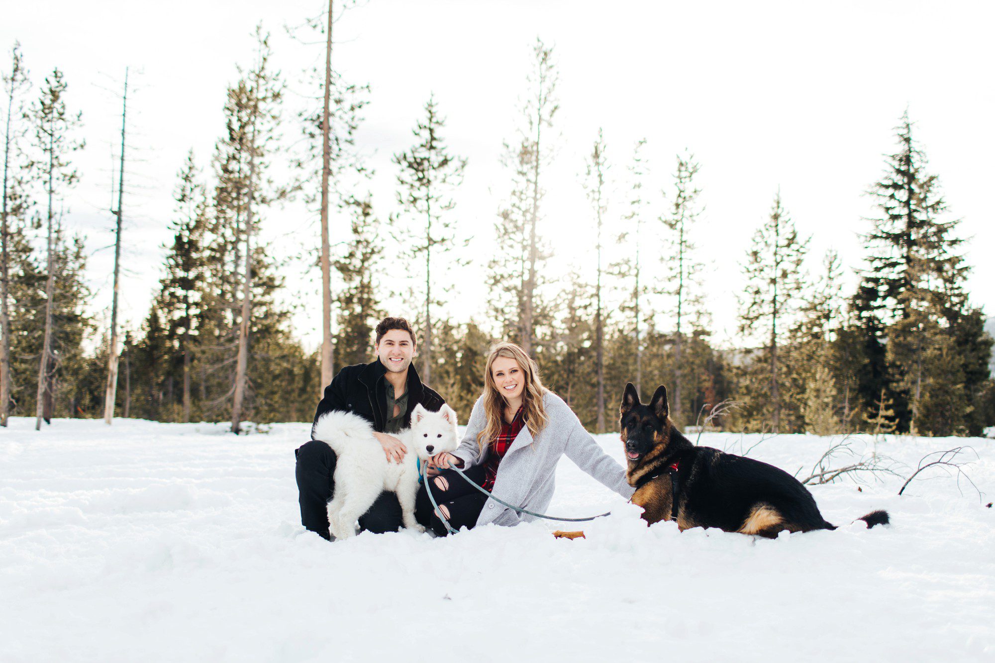 Central Oregon couple with dogs in the snow