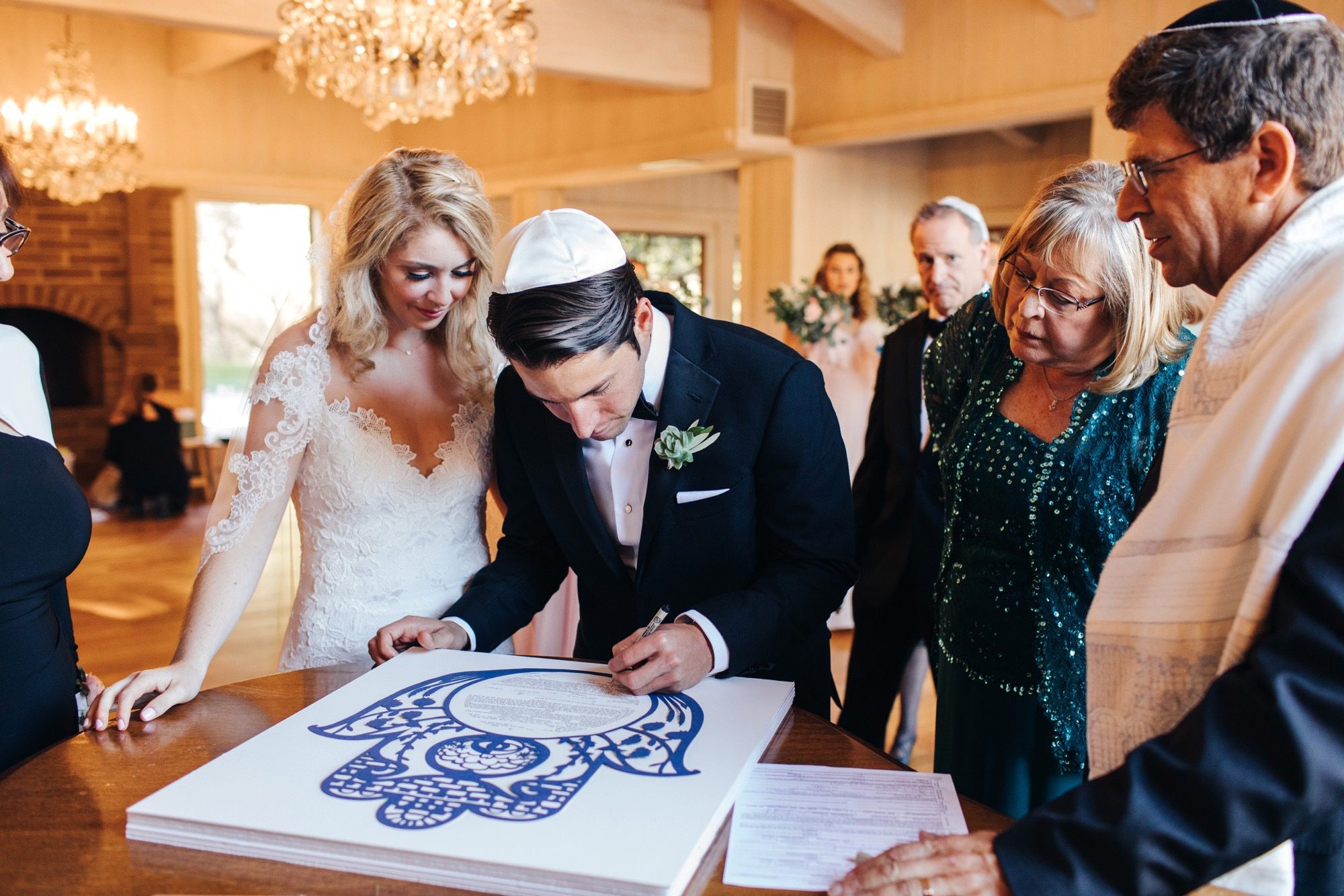 Bride and Groom at Jewish wedding signing the ketubah